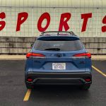 2026 Toyota Corolla Cross Hybrid XSE in Cavalry Blue, taillights on, rear view,