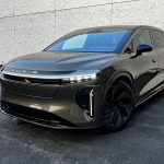 2026 Lucid Gravity Grand Touring in Supernova Bronze, front 3/4 view, headlights on,