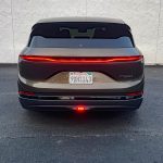 2026 Lucid Gravity Grand Touring in Supernova Bronze, rear view, taillights on,
