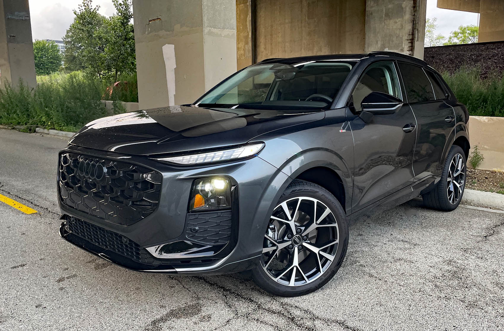 2026 Audi Q3 S Line in Daytona Gray Pearl , front 3/4, headlights on