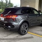 2026 Audi Q3 S Line in Daytona Gray Pearl, rear 3/4 industrial, taillights on