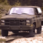 Chevrolet Blazer M1009, running through mud, dark camo