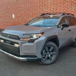 2026 Toyota RAV4 Woodland PHEV in Urban Rock, front 3/4 view,