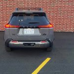 2026 Toyota RAV4 Woodland PHEV in Urban Rock, rear view, taillights on, gray,