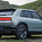 Rivian R3 Concept, rear 3/4 view. light blue, mountains,